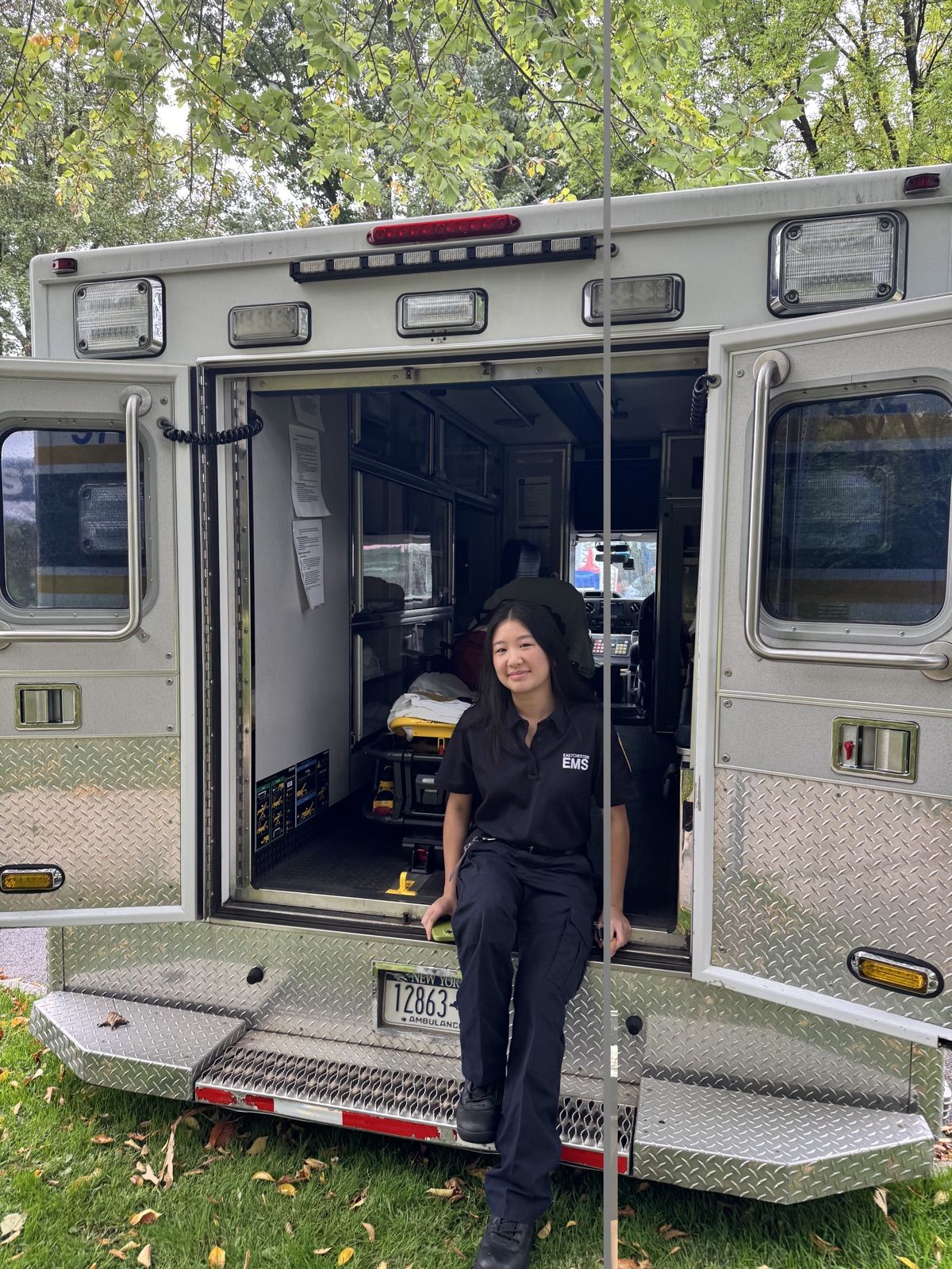 Rachel at the back of an open ambulance